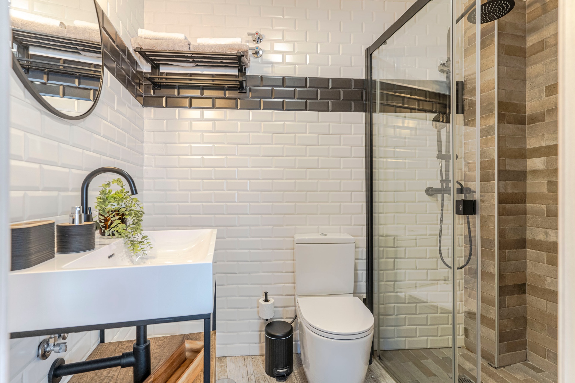 Baño spa con azulejo metro blanco y grifería negra mate
